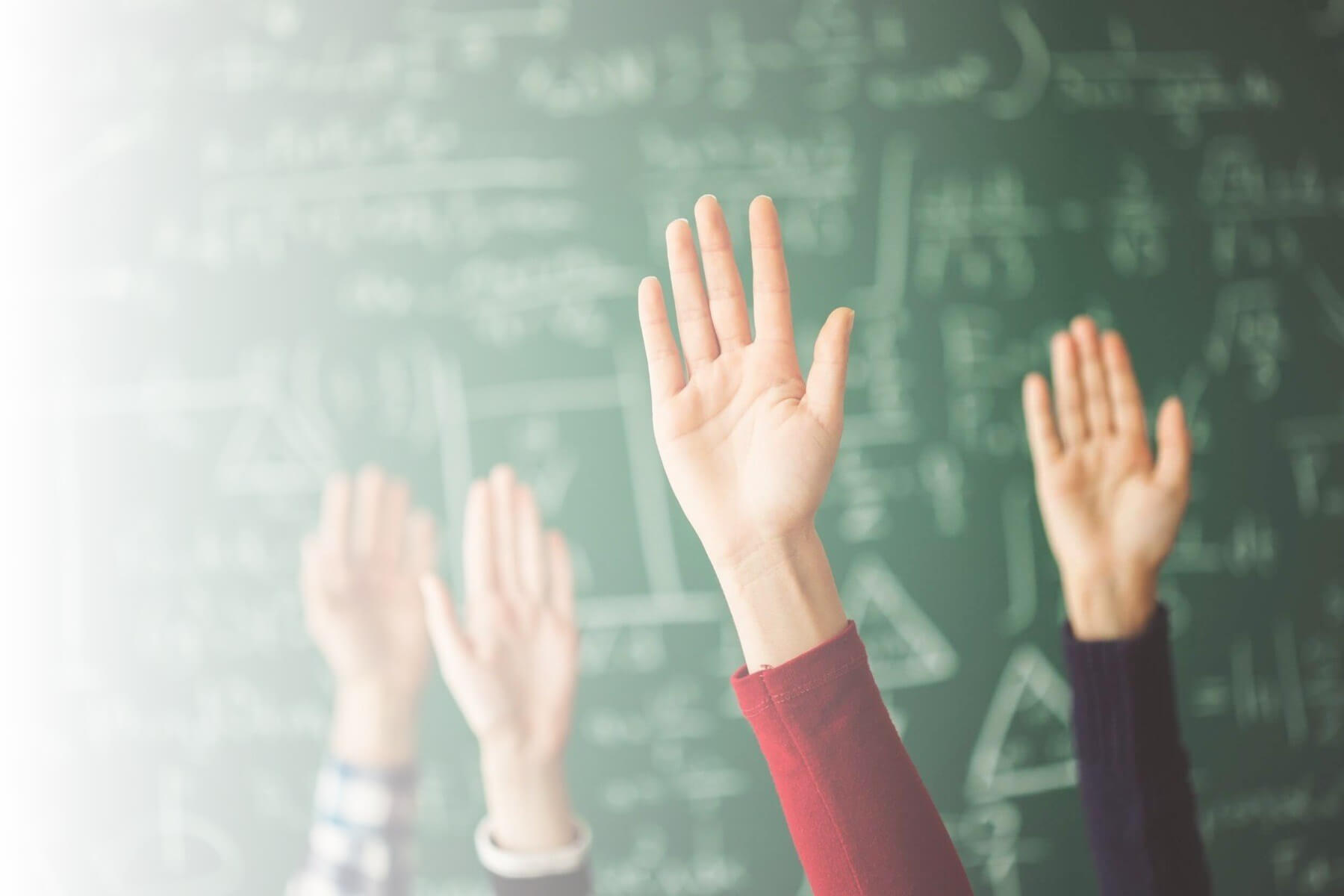 kids raising hands